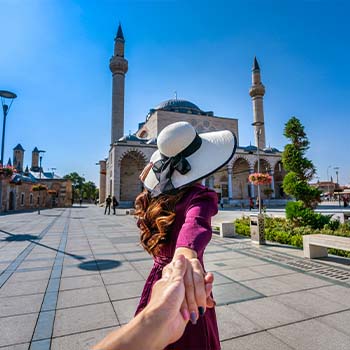 women-tourists-holding-man-s-hand-leading-him-mosque-konya-turkey women-tourists-holding-man-s-hand-leading-him-mosque-konya-turkey